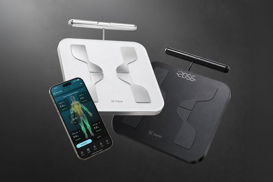 Black and white Hume Pod 2.0 body-composition analyzers beside the Hume Health app